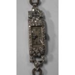 A platinum and diamond rectangular cased lady's dress wristwatch, the jewelled movement detailed '