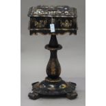 A mid-Victorian black papier-mâché work table with overall mother-of-pearl and gilt decoration,