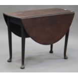 A George III mahogany oval drop-flap table, on turned legs and pad feet, height 72cm, width 122cm,