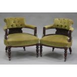 A pair of Victorian mahogany tub back salon armchairs, upholstered in green velour, raised on ring