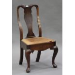 An early 18th century oak splat back chair with a drop-in seat, raised on cabriole legs, height