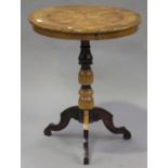 A 19th century Italian walnut and parquetry inlaid circular wine table, on a turned column and