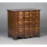 An 18th century Dutch yew serpentine fronted commode, fitted with four long drawers, on turned bun