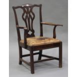 A George III mahogany pierced splat back elbow chair, on moulded block legs, height 97cm, width