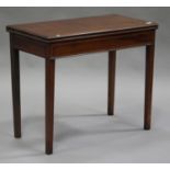 A George III mahogany fold-over tea table with satinwood crossbanded decoration, raised on square