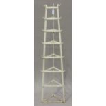 An early 20th century wrought iron saucepan stand of eight-tier graduated triangular form, height