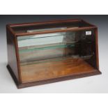 A late Victorian mahogany framed counter top bijouterie display case, fitted with a mirrored fall