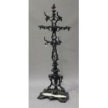 A Victorian black enamelled cast iron hallstand, probably by Coalbrookdale, the overall scrolling