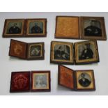 A pair of late 19th century portrait ambrotypes, within a bois durci folding case, height 9.5cm,