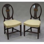 A pair of late 19th century Hepplewhite style mahogany pierced splat back dining chairs with