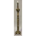 A 19th century giltwood and gesso lamp standard, the column decorated with leaf sprays, on four