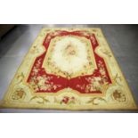 An Aubusson carpet, France, early 20th century, the cream field with a floral medallion, within a