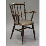 An early 20th century walnut bar and spindle back armchair with pokerwork seat, on turned legs,