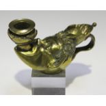 A late 19th century cast brass novelty chamberstick, modelled in the form of a satyr mask holding