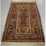 A Beluche rug, Afghan/Persian borders, early 20th century, the terracotta field with a column of