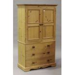 A modern pine side cabinet, fitted with a pair of panelled doors above three drawers, height