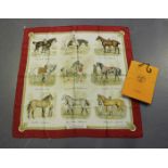 An Hermès silk scarf, printed with nine vignettes of horses, titled 'Les Robes', 90cm x 87cm,