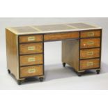 A mid/late 20th century campaign style satinwood and brass mounted twin pedestal desk by 'Baker