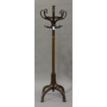 An early 20th century Thonet bentwood hat stand, on scrollwork supports, height 205cm.Buyer’s