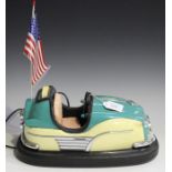 A late 20th century radio cassette player in the form of a bumper car with working lights and