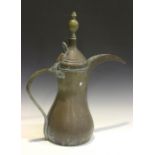 A large Middle Eastern copper and brass mounted ewer, height 70cm.Buyer’s Premium 29.4% (including