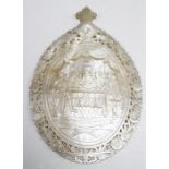 An early 20th century carved mother-of-pearl oval plaque depicting the Last Supper above an