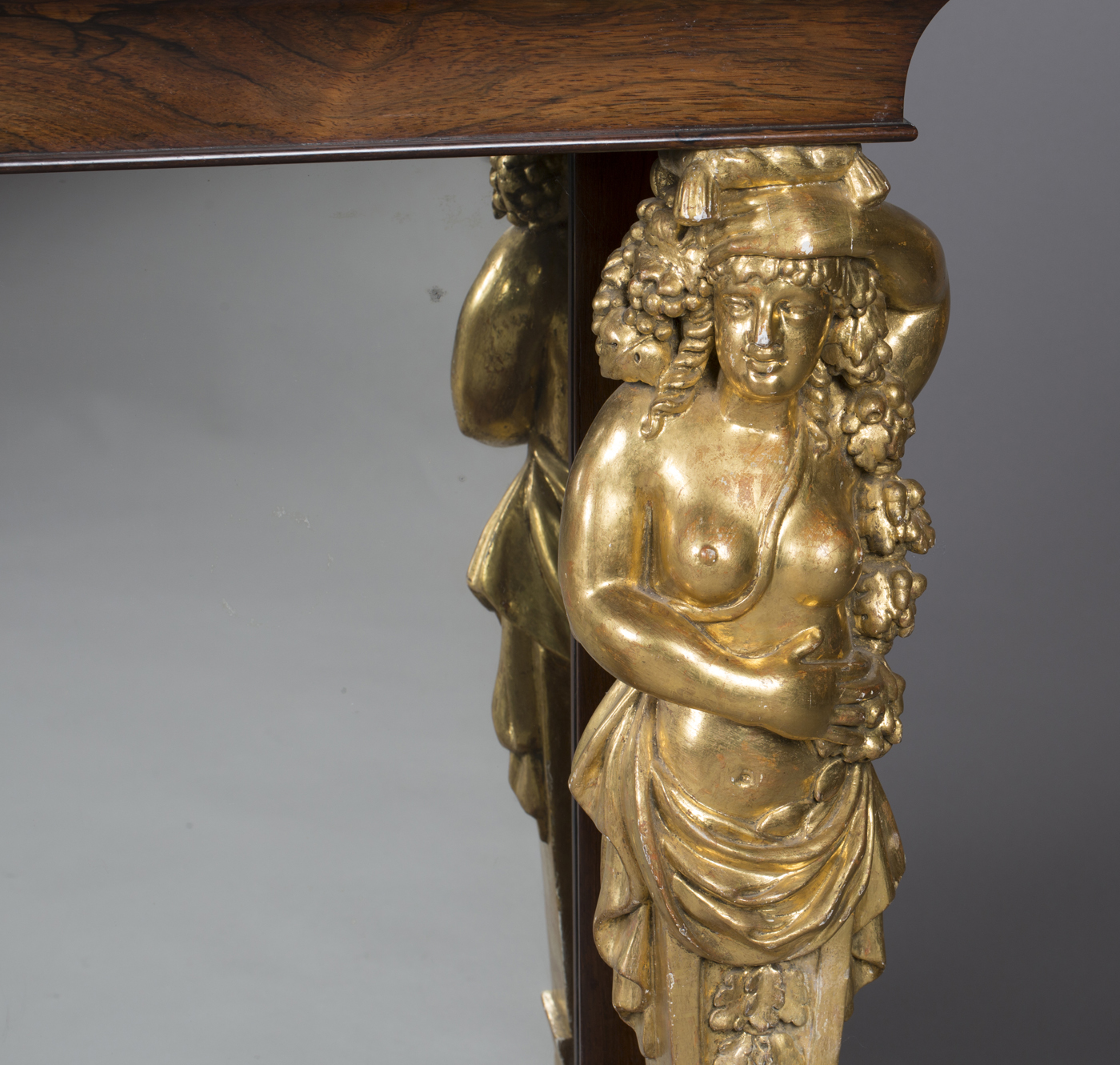 A Regency rosewood console table, the later veneered yew top supported by a pair of giltwood and - Image 4 of 5