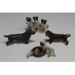 An early 20th century cold painted lead group of three seated terriers, height 5.5cm, two similar