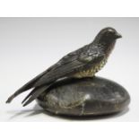 An early 20th century Austrian cold painted bronze model of a swallow, perched on a rounded stone
