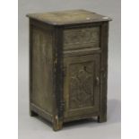A 20th century Jacobean style bedside cabinet, carved with flowers and leaf scrolls, the top with
