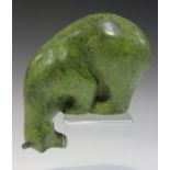 An Art Deco green patinated cast bronze model of a polar bear peering downwards, bearing