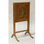 A George III satinwood writing screen, the fall front with an oval panel painted with a classical