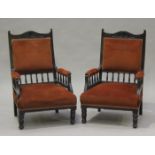 A pair of Edwardian stained beech framed salon armchairs with carved decoration, the upholstered