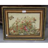 A mid-19th century woolwork panel of a bird and butterflies beside a strawberry bush, 33cm x 43cm,
