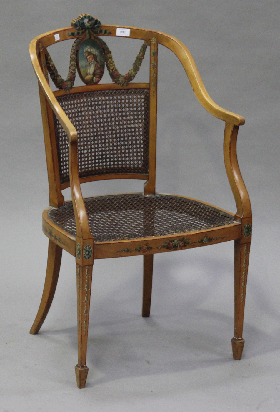 An Edwardian Neoclassical Revival satinwood tub back salon armchair, the painted ribbon, portrait