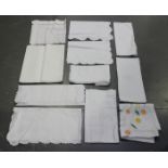 A quantity of whitework, including mainly linen tablecloths and place mats.Buyer’s Premium 29.4% (