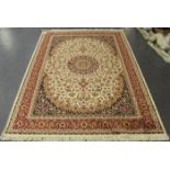 A modern machine made Kashan style rug, the ivory field with a flowerhead medallion, supported by