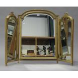 A late 19th century gilt gesso framed triptych dressing table mirror, the frames with ribbon