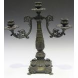 A Regency brown patinated cast bronze three light candelabrum, the central column issuing a pair