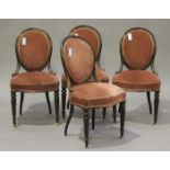 A set of four late Victorian walnut framed salon chairs, the seats and backs upholstered in pink