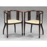 A pair of Edwardian mahogany tub back salon armchairs, height 77cm, width 55cm.Buyer’s Premium 29.4%