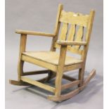 A modern rustic stripped pine rocking armchair, height 93cm, width 70cm.Buyer’s Premium 29.4% (