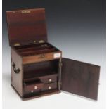 An early 19th century mahogany apothecary's chest, the hinged lid and door enclosing drawers,