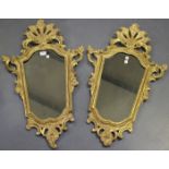 A pair of mid-18th century giltwood and gesso mirror frames of cartouche form, the later glass