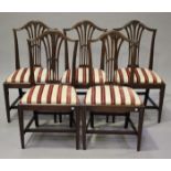 A set of five George III mahogany pierced splat back dining chairs with drop-in seats, on square