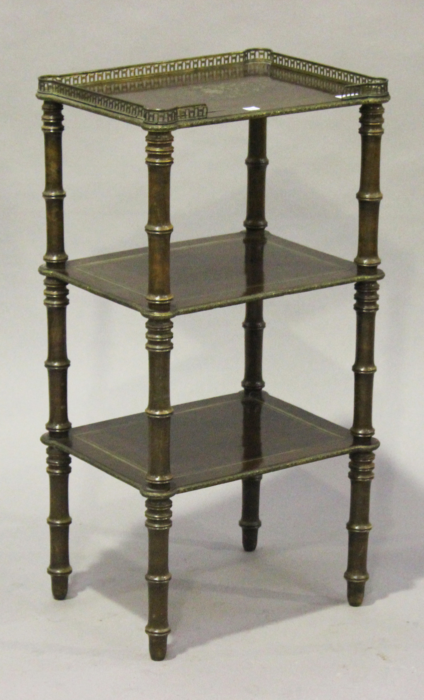 An early 20th century French mahogany three-tier étagère, the top inlaid in brass with leaf scrolls,