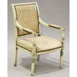 An early 20th century French Louis XVI style cream painted showframe armchair, raised on turned