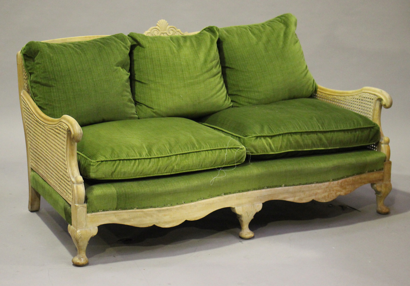 An early 20th century bleached mahogany bergère settee with scroll arms, on cabriole legs, height