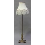 An early 20th century gilt brass adjustable lamp standard with a fluted column, supported on a