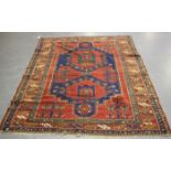 A Kazak rug, West Caucasus, late 19th/early 20th century, the deep red field with a blue shaped